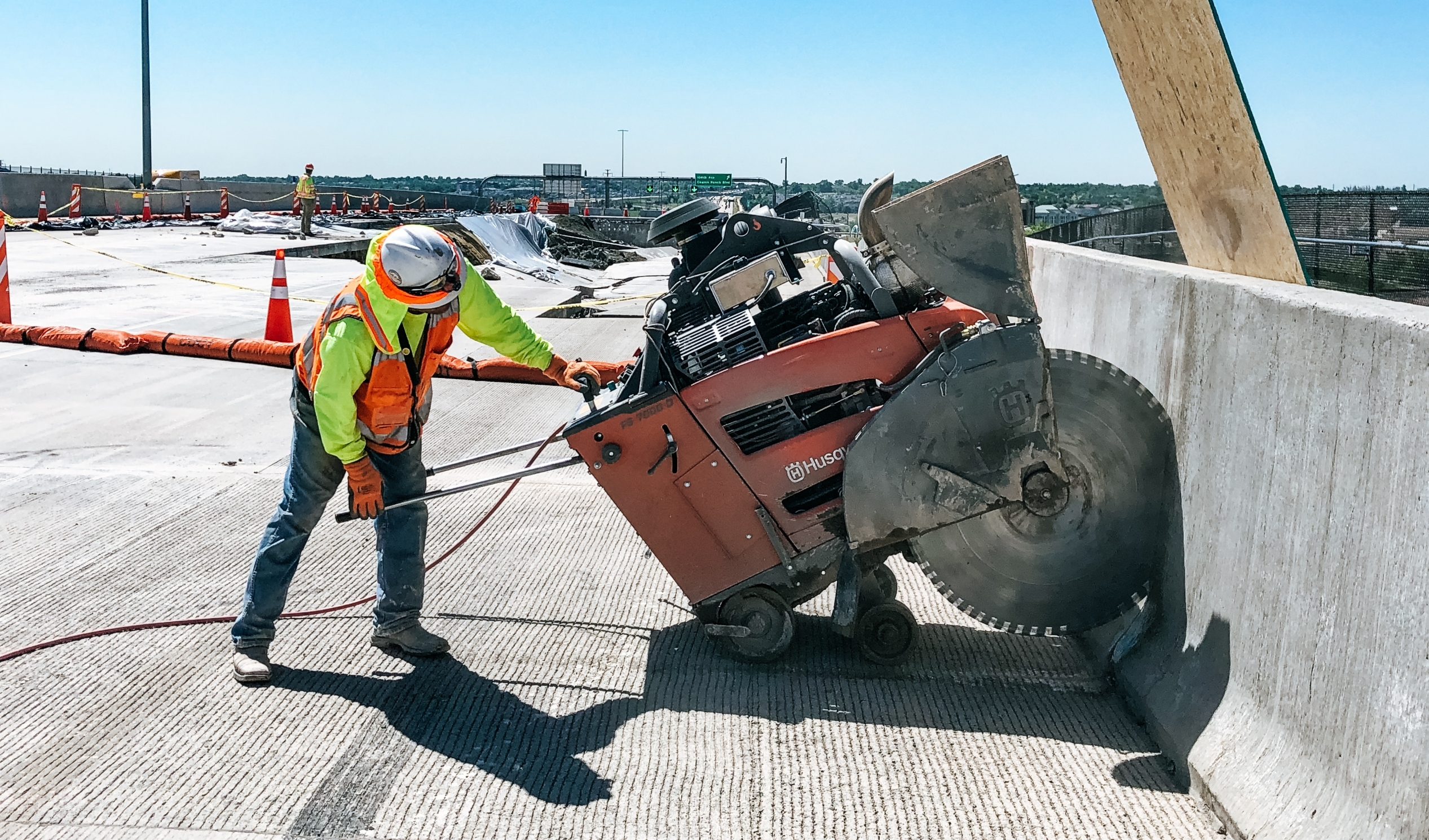 concrete specialist cutting concrete on the highway